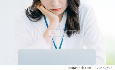 Woman/businesswoman thinking while using a computer Woman/businesswoman thinking while using a computer 120482648