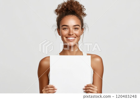 Cheerful woman holding a blank sign. Mockup or text placement Cheerful woman holding a blank sign. Mockup or text placement 120483248