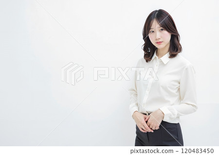 Woman standing in front of white background Woman standing in front of white background 120483450