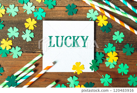 White sign with the word lucky written on it is surrounded by green White sign with the word lucky written on it is surrounded by green 120483916