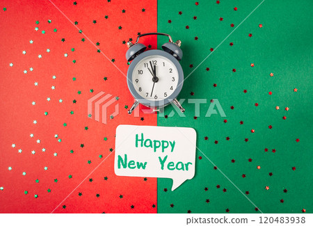 Clock is on a green background with a white paper that says Happy New Year 120483938