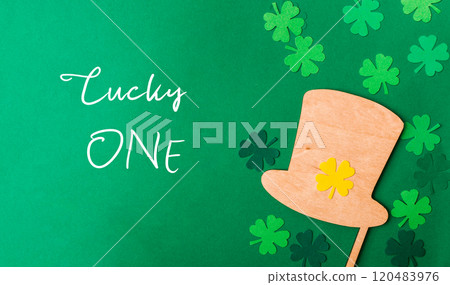 A green background with a wooden hat and four shamrocks A green background with a wooden hat and four shamrocks 120483976