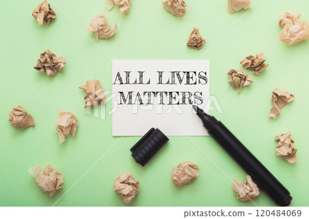 Piece of paper with the words all lives matter written on it 120484069