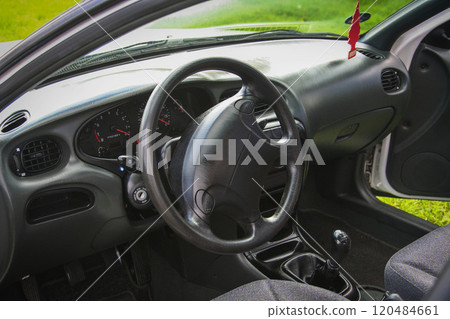 sleek classic white sedan parked on a grassy field, showcasing its elegant design and functionality in an outdoor environment sleek classic white sedan parked on a grassy field, showcasing its elegant design and functionality in an outdoor environment 120484661