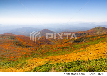 Mount Kurikoma, which straddles the three prefectures of Miyagi, Iwate, and Akita, features a view of the vibrant autumn foliage covering the slopes from the summit. 120484696