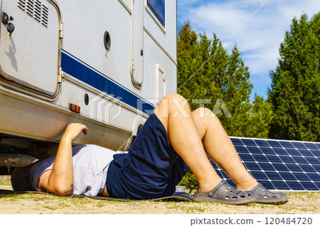 Man repairing bottom of the rv caravan 120484720