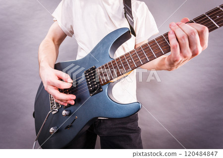 Close up of man playing on electric guitar 120484847