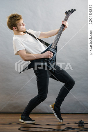 Man playing on electric guitar 120484882