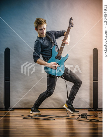 Young man playing electric guitar Young man playing electric guitar 120484912