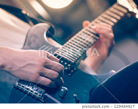 Close up of man playing on electric guitar 120484927