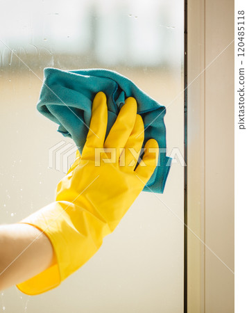 Hand cleaning window at home using detergent rag Hand cleaning window at home using detergent rag 120485118