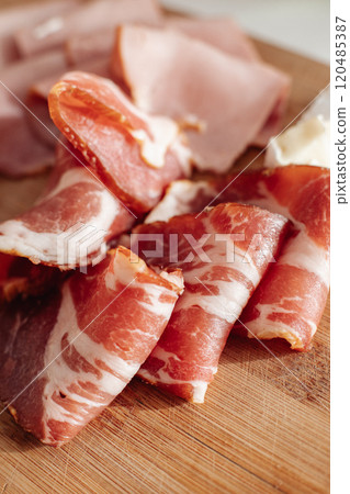 dried meat sliced on the table dried meat sliced on the table 120485387