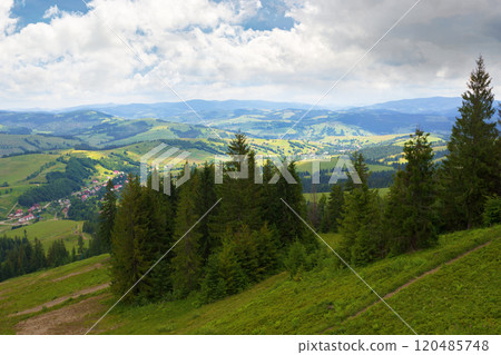 beautiful view of a countryside in carpathian mountains. remote district. cloudy weather in summer. trees on the steep slope. village in the valley. dappled light. green environment beautiful view of a countryside in carpathian mountains. remote district. cloudy weather in summer. trees on the steep slope. village in the valley. dappled light. green environment 120485748