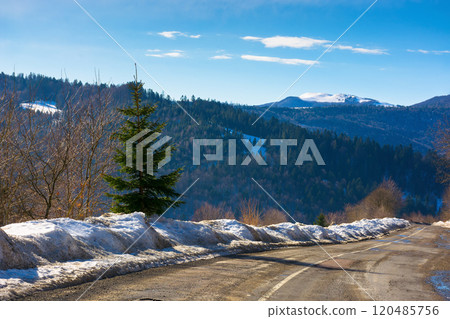 road in carpathian mountains. travel destination. sunny day in winter. beautiful view road in carpathian mountains. travel destination. sunny day in winter. beautiful view 120485756