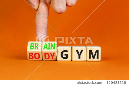 Body vs brain gym symbol. Businessman turns wooden cubes and changes words Body gym to Brain gym. Beautiful orange table orange background, copy space. Business and body vs brain gym concept. 120485816