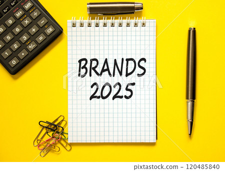 Planning brands 2025 new year symbol. Concept words Brands 2025 on beautiful white note. Beautiful yellow paper background. Black calculator. Business brands 2025 new year concept. Copy space. 120485840