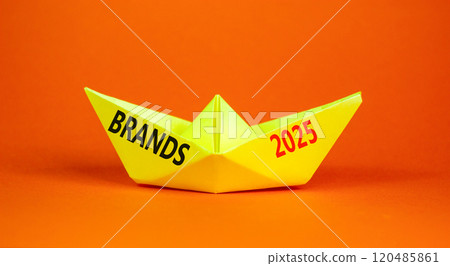 Planning brands 2025 new year symbol. Concept words Brands 2025 on beautiful yellow paper boat. Beautiful orange paper background. Business brands 2025 new year concept. Copy space. 120485861