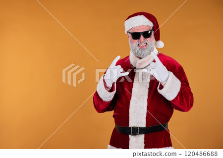 Santa Claus Pointing at Camera while Wearing Sunglasses 120486688