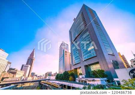 Tokyo cityscape in Japan: View of NTT Docomo Yoyogi Building, Yoyogi Station, yellow trains, etc. from the New South Exit of Shinjuku Station (22nd) 120486736