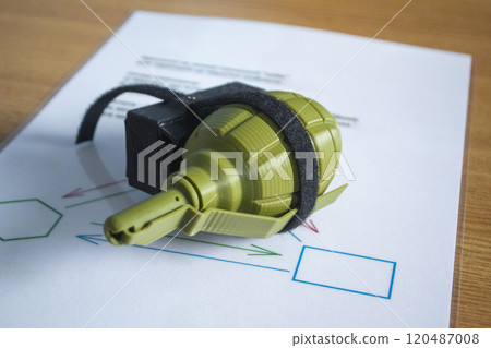 Prototype model of grenade ammunition printed on 3D printer. Small models of grenade defensive weapon printed on 3D printer from molten plastic on table. New modern innovation printing technology 120487008