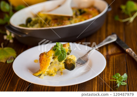 cauliflower and brussel sprouts casserole with cheese, in a plate on a wooden table cauliflower and brussel sprouts casserole with cheese, in a plate on a wooden table 120487979