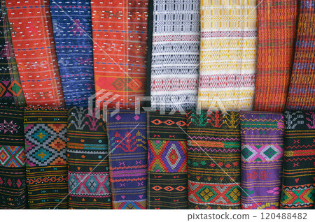 Rows of colorful traditional woven fabric called Ulos sold as souvenirs showing the authentic culture and heritage of the Batak indigenous people of Indonesia 120488482