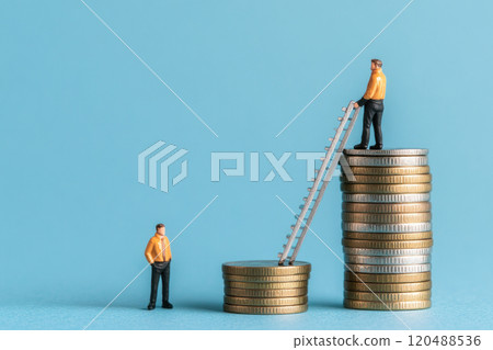 Miniature figures climbing coins symbolizing financial growth and investment. 120488536