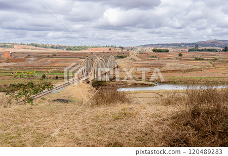 Historic Railway Bridge Over River in Rural Madagascar Landscape. 120489283