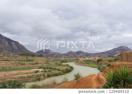 River Flowing Through Farmlands with Locals Washing Clothes. River Flowing Through Farmlands with Locals Washing Clothes. 120489310