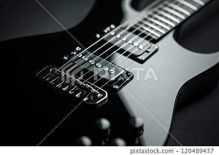 Black electric guitar reflecting light on dark background Black electric guitar reflecting light on dark background 120489437