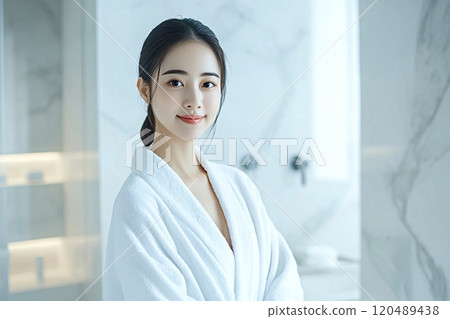 Beautiful asian woman wearing bathrobe smiling in modern bathroom Beautiful asian woman wearing bathrobe smiling in modern bathroom 120489438