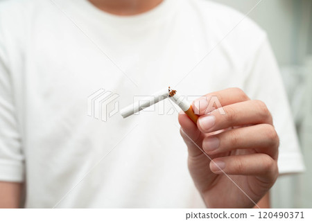 Quit smoking, Asian teenage man breaking destroy cigarette in hand. Quit smoking, Asian teenage man breaking destroy cigarette in hand. 120490371