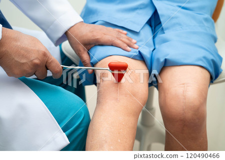 Asian doctor knock on knee reflex nerve for check and treatment senior patient in hospital. Asian doctor knock on knee reflex nerve for check and treatment senior patient in hospital. 120490466