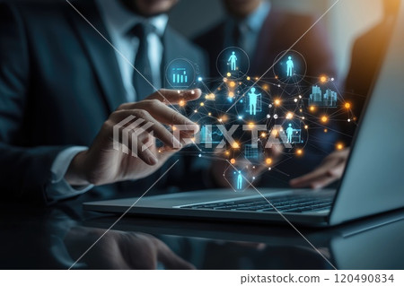 A man is using a laptop with a screen that shows a network of people A man is using a laptop with a screen that shows a network of people 120490834