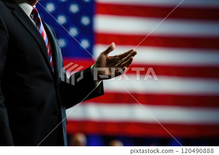 Businessman Gesturing with American Flag Background, Symbolizing Patriotism, Leadership 120490888