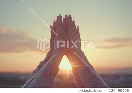 A group of people are holding hands in a pyramid formation 120490906