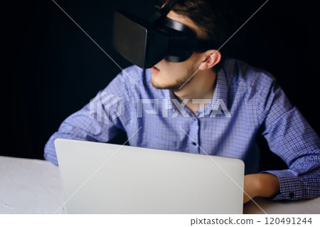 A person uses virtual reality on a laptop, blending technology with productivity and innovation in a modern workspace A person uses virtual reality on a laptop, blending technology with productivity and innovation in a modern workspace 120491244