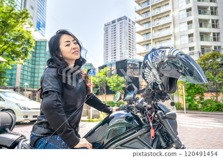 A female rider touring Yokohama on a cruiser bike A female rider touring Yokohama on a cruiser bike 120491454