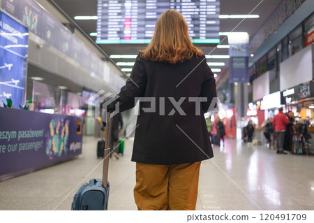 Portrait of positive cheerful traveler woman hold ticket ready enjoy voyage tour passenger walk in airport terminal to boarding gate. Attractive beautiful female tourist excited to go travel abroad by Portrait of positive cheerful traveler woman hold ticket ready enjoy voyage tour passenger walk in airport terminal to boarding gate. Attractive beautiful female tourist excited to go travel abroad by 120491709