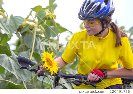 Beautiful woman cyclist with a bicycle on the nature. Healthy lifestyle and sport Beautiful woman cyclist with a bicycle on the nature. Healthy lifestyle and sport 120491726