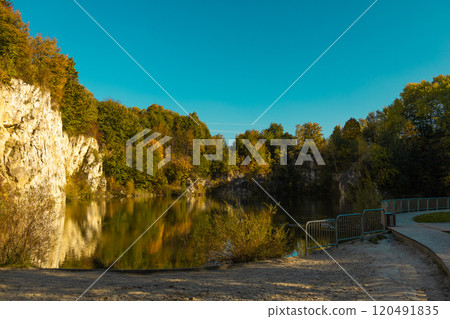 Autumn forest lake in Poland. Autumn lake in autumn forest. The autumn foliage of the trees is reflected in the lake water Autumn forest lake in Poland. Autumn lake in autumn forest. The autumn foliage of the trees is reflected in the lake water 120491835