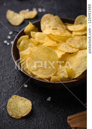 Crispy salty homemade potato chips 120491989