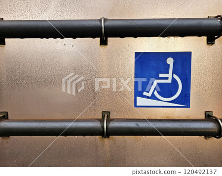 Disabled Ramp Access Sign with metal handrail on tram station. 120492137