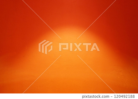Spotlight on the surface of orange painting concrete wall background. 120492188