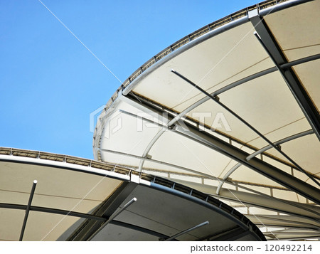 Exterior view of rounded roof with blue sky. Exterior view of rounded roof with blue sky. 120492214