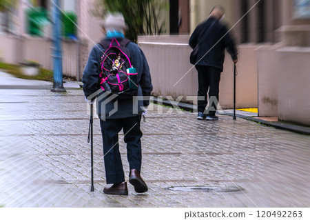 Yokohama cityscape in Japan. Road surface wet from rain... slippery, hard underfoot... Aging society, elderly man with cane (wearing mask) 120492263