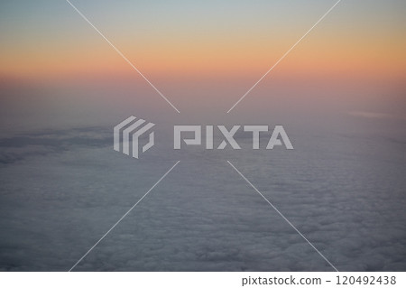 a dawn above the clouds through the porthole 120492438