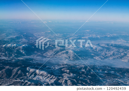 view of mountains covered with snow from an airplane window, Cyprus 120492439