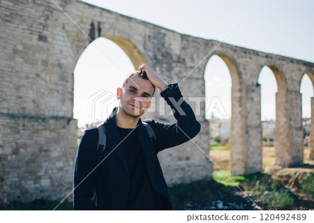 young man near the ancient Kamares Aqueduct, Larnaca, Cyprus young man near the ancient Kamares Aqueduct, Larnaca, Cyprus 120492489