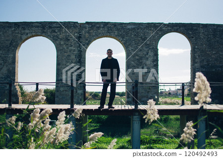 young man near the ancient Kamares Aqueduct, Larnaca, Cyprus young man near the ancient Kamares Aqueduct, Larnaca, Cyprus 120492493